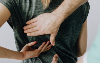 Chiropractor explaining why not to wait until you hurt to receive preventative chiropractic adjustments