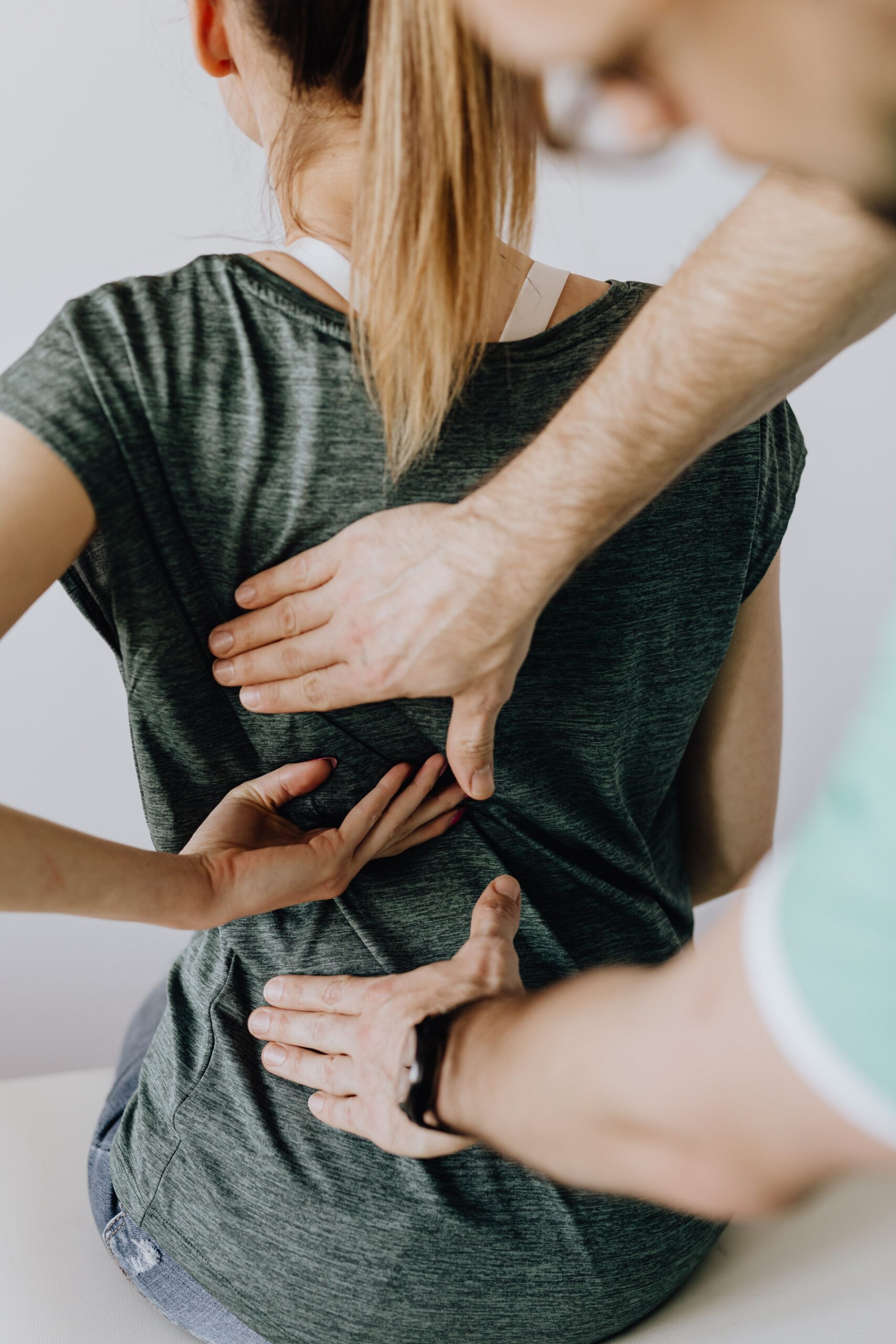Chiropractor explaining why not to wait until you hurt to receive preventative chiropractic adjustments