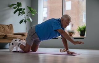 Adult performing a controlled bird dog exercise to improve core strength and stability in Mooresville, NC